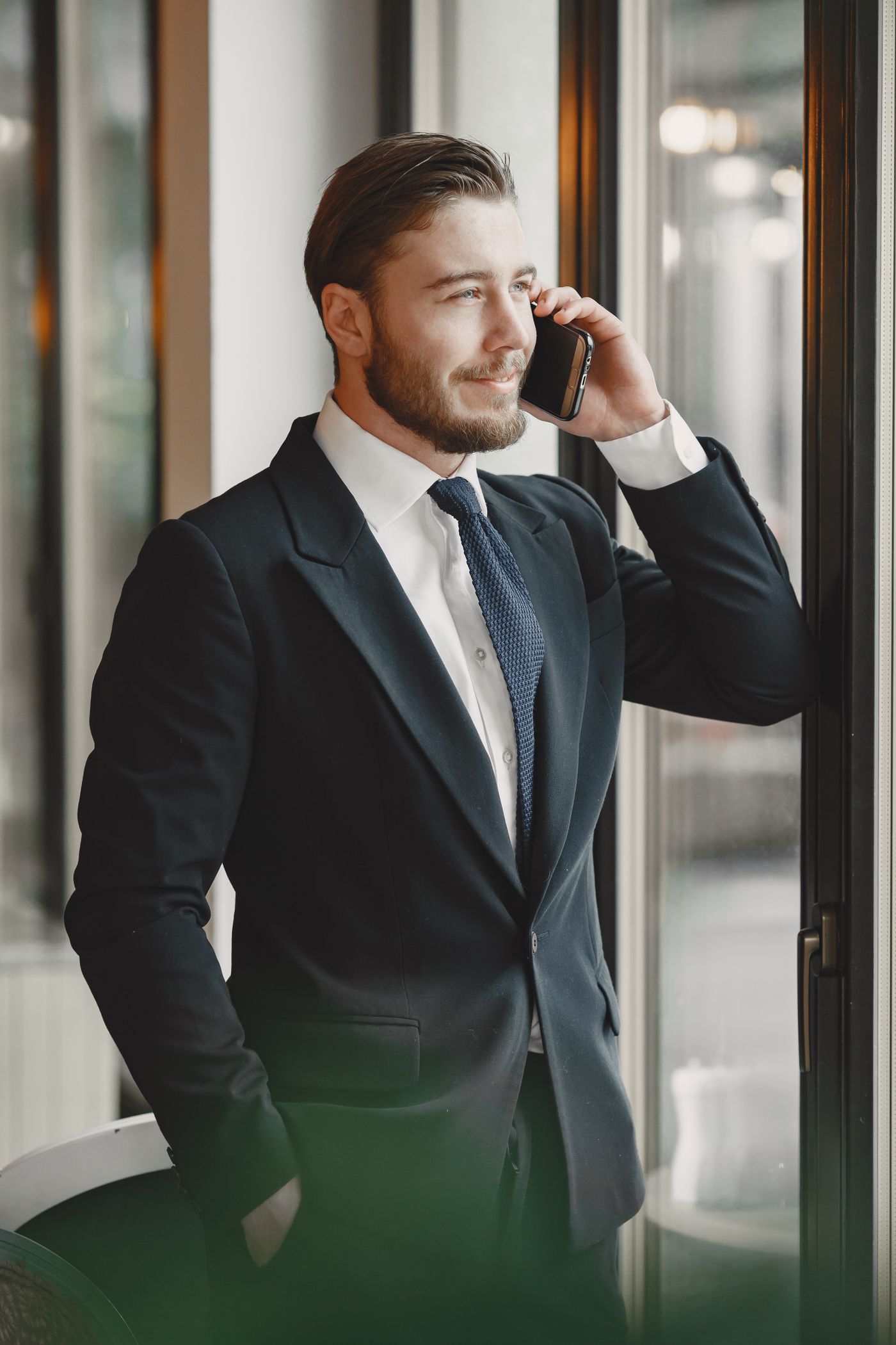 A perfectly tailored unbranded suit in muted tones on a wooden hanger